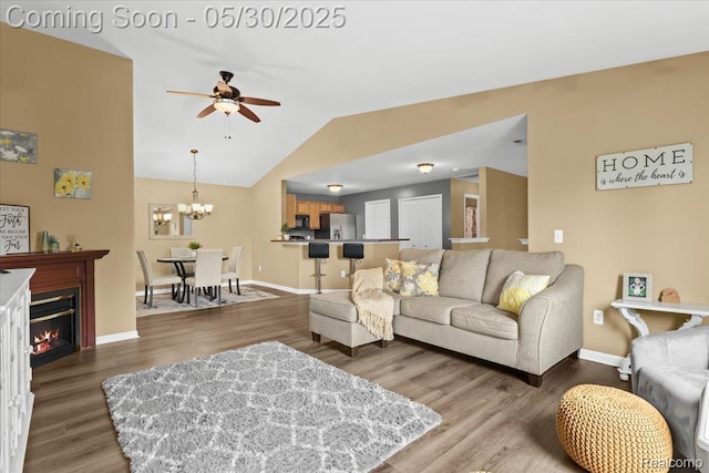 51623 Hale Ln, Chesterfield, MI 48051 - living area featuring a ceiling fan, wood finished floors, lofted ceiling, baseboards, and a chandelier