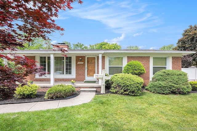 6439 Rockdale Ct, Dearborn Heights, MI 48127 - ranch-style home with brick siding, a porch, a chimney, and a front yard