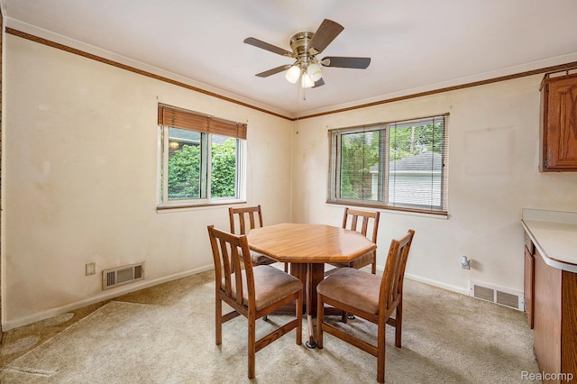 6439 Rockdale Ct, Dearborn Heights, MI 48127 - dining room featuring ceiling fan, light colored carpet, baseboards, and crown molding