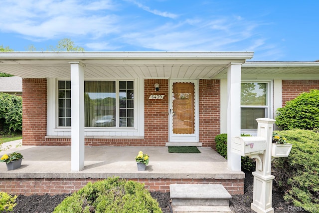 6439 Rockdale Ct, Dearborn Heights, MI 48127 - entrance to property with a porch and brick siding