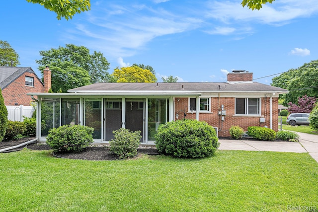 6439 Rockdale Ct, Dearborn Heights, MI 48127 - view of front of house with a chimney, brick siding, and a sunroom