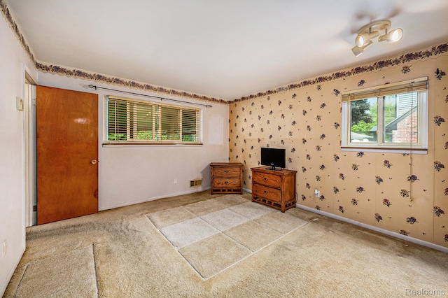 6439 Rockdale Ct, Dearborn Heights, MI 48127 - unfurnished bedroom with light carpet, baseboards, and wallpapered walls