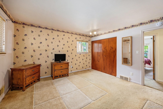 6439 Rockdale Ct, Dearborn Heights, MI 48127 - unfurnished bedroom featuring a closet, light colored carpet, and baseboards