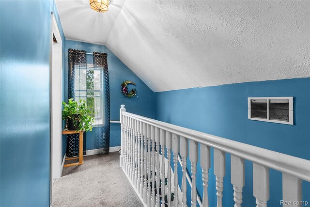 306 Hamilton St, Byron, MI 48418 - hallway featuring carpet, lofted ceiling, a textured ceiling, and baseboards