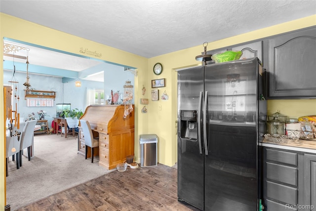 306 Hamilton St, Byron, MI 48418 - kitchen featuring stainless steel refrigerator with ice dispenser, wood finished floors, a textured ceiling, light countertops, and gray cabinetry