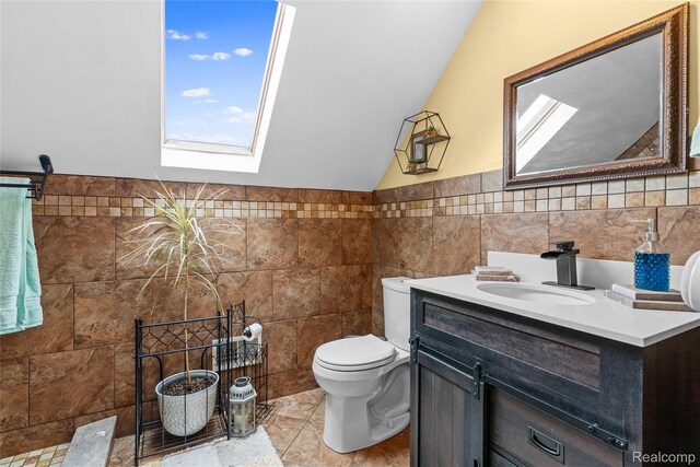 306 Hamilton St, Byron, MI 48418 - bathroom featuring a skylight, tile walls, vanity, toilet, and vaulted ceiling