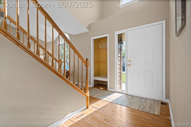 5602 Adderstone Dr, Clarkston, MI 48346 - foyer featuring wood-type flooring, stairway, and baseboards
