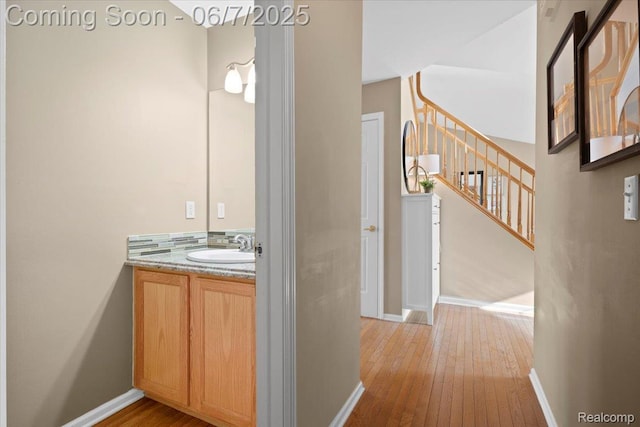 5602 Adderstone Dr, Clarkston, MI 48346 - bathroom with wood-type flooring, vanity, and baseboards