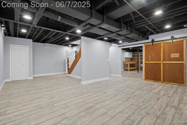 5602 Adderstone Dr, Clarkston, MI 48346 - finished basement with baseboards, stairway, wood finished floors, and a barn door