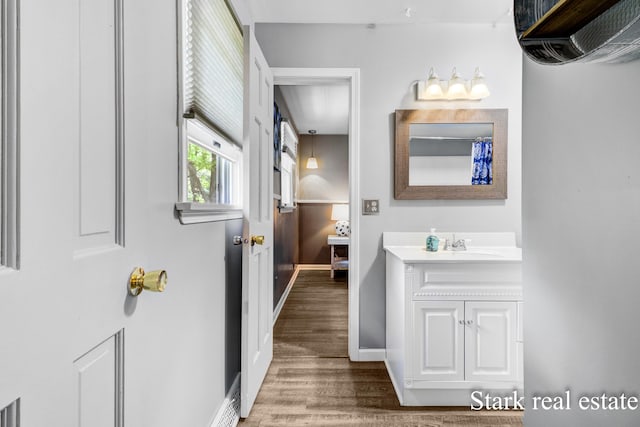 300 N 2nd Ave, Fruitport, MI 49415 - bathroom featuring vanity, wood finished floors, and baseboards