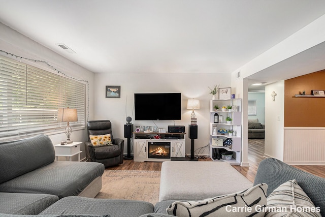 6716 Cascade Rd SE, Grand Rapids, MI 49546 - living room featuring wood finished floors, wainscoting, and plenty of natural light