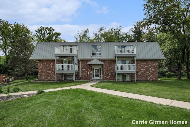 6716 Cascade Rd SE, Grand Rapids, MI 49546 - view of front of property with a balcony, a front lawn, and brick siding