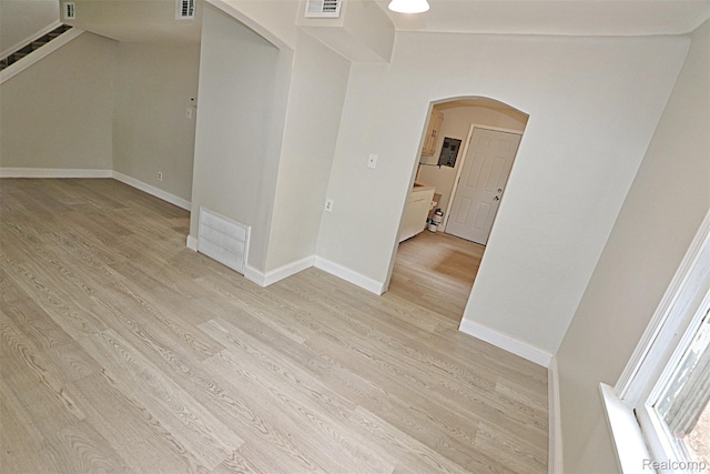 19444 Inkster Rd, Redford, MI 48240 - empty room with arched walkways, light wood-type flooring, stairway, and baseboards