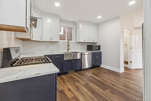 2547 Seyburn St, Detroit, MI 48214 - kitchen with stainless steel appliances, a sink, dark wood-type flooring, white cabinetry, and baseboards
