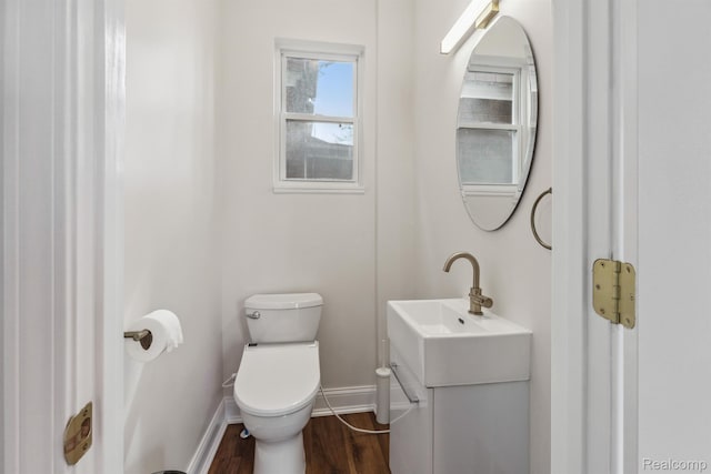 2547 Seyburn St, Detroit, MI 48214 - half bath featuring baseboards, vanity, toilet, and wood finished floors