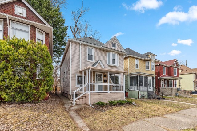 2547 Seyburn St, Detroit, MI 48214 - view of front facade featuring a porch and a residential view