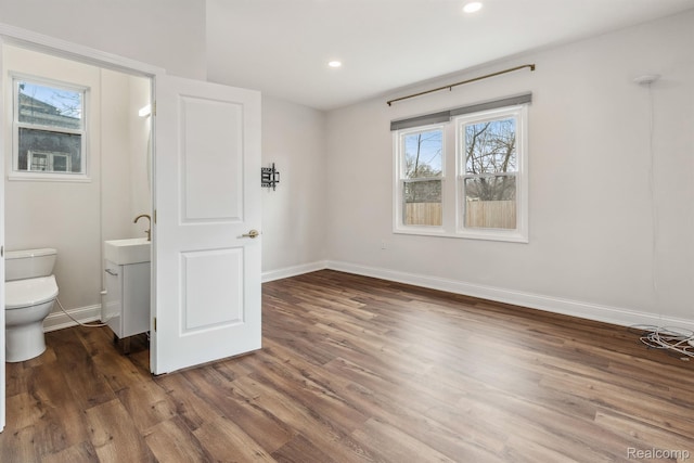 2547 Seyburn St, Detroit, MI 48214 - unfurnished bedroom featuring wood finished floors, baseboards, recessed lighting, and a sink