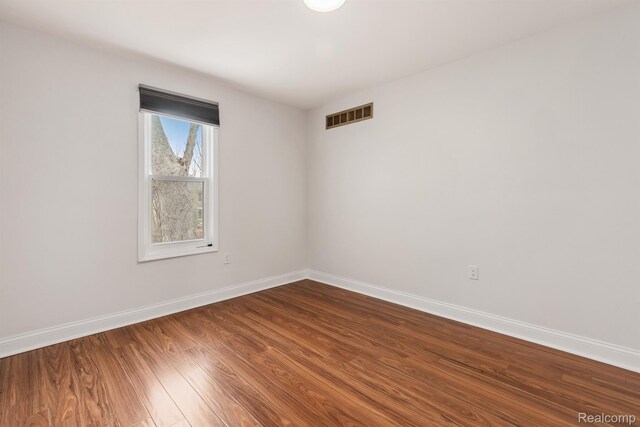 2547 Seyburn St, Detroit, MI 48214 - empty room with baseboards and dark wood-style floors