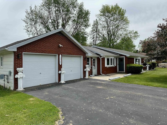 13405 S Gera Rd, Birch Run, MI 48415 - ranch-style house featuring brick siding, a garage, a front yard, and asphalt driveway