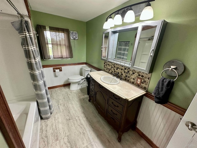 13405 S Gera Rd, Birch Run, MI 48415 - full bathroom with a wainscoted wall, vanity, wood finished floors, and shower / tub combo with curtain