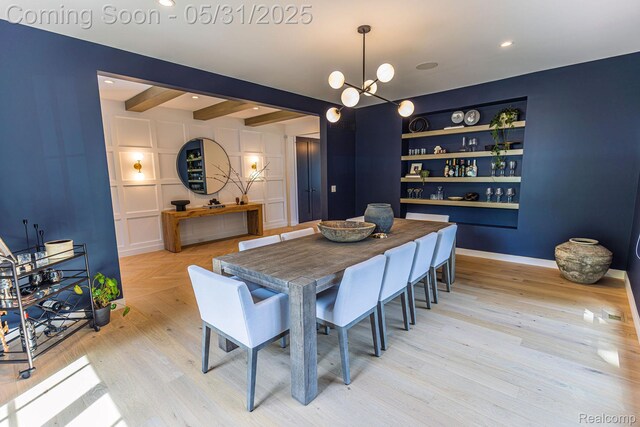 923 S Glenhurst Dr, Birmingham, MI 48009 - dining area with built in shelves, a chandelier, light wood-type flooring, beam ceiling, and baseboards
