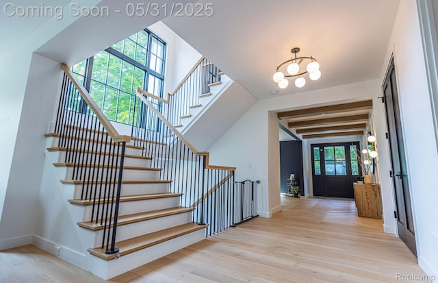 923 S Glenhurst Dr, Birmingham, MI 48009 - stairway with wood finished floors, a chandelier, and baseboards