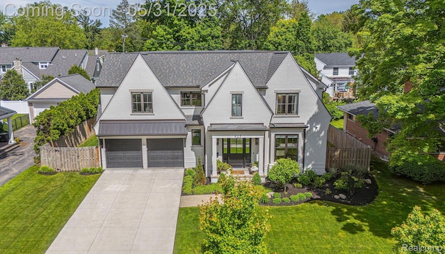 923 S Glenhurst Dr, Birmingham, MI 48009 - view of front of house featuring stucco siding, a garage, and driveway