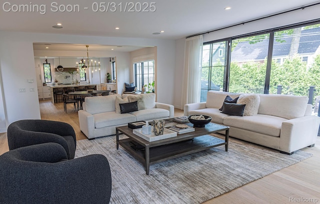 923 S Glenhurst Dr, Birmingham, MI 48009 - living area featuring wood finished floors, a chandelier, and recessed lighting