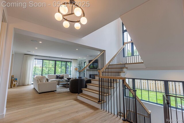 923 S Glenhurst Dr, Birmingham, MI 48009 - stairway with wood finished floors, plenty of natural light, a chandelier, and recessed lighting