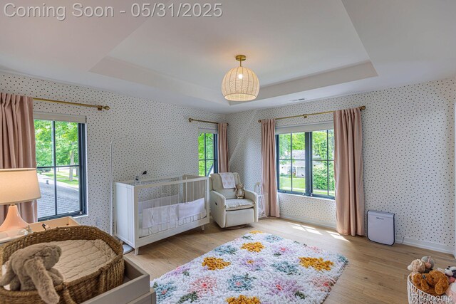 923 S Glenhurst Dr, Birmingham, MI 48009 - bedroom featuring a raised ceiling, wallpapered walls, wood finished floors, and baseboards