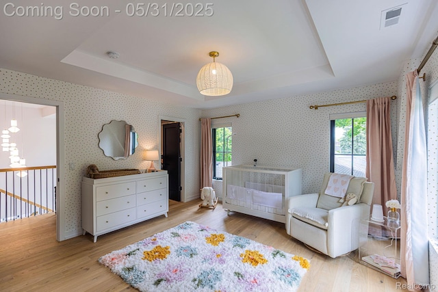 923 S Glenhurst Dr, Birmingham, MI 48009 - bedroom with a raised ceiling, light wood-style floors, and wallpapered walls