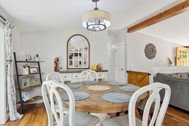 5885 Lammers Rd, Hastings, MI 49058 - dining space with a chandelier, wood finished floors, and beamed ceiling