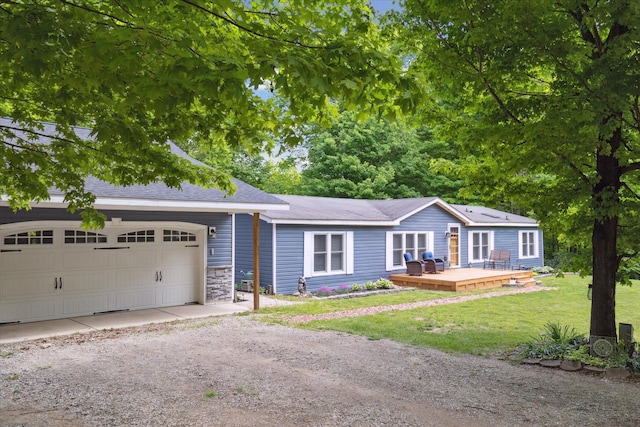 5885 Lammers Rd, Hastings, MI 49058 - single story home featuring a wooden deck, dirt driveway, a front yard, an attached garage, and roof with shingles