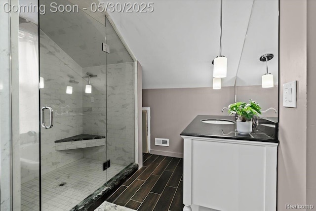 114 N Connecticut Ave, Royal Oak, MI 48067 - bathroom featuring double vanity, wood tiled floors, a shower stall, and baseboards