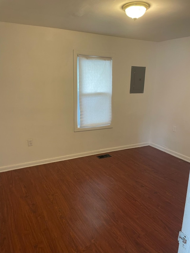 2194 E Bristol Rd, Burton, MI 48529 - spare room with electric panel, dark wood-type flooring, and baseboards