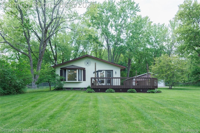 4447 Stanley Rd, Genesee, MI 48437 - rear view of house with a wooden deck and a lawn