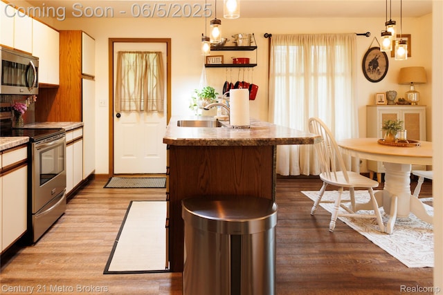 4447 Stanley Rd, Genesee, MI 48437 - kitchen with appliances with stainless steel finishes, a sink, dark wood finished floors, and white cabinets