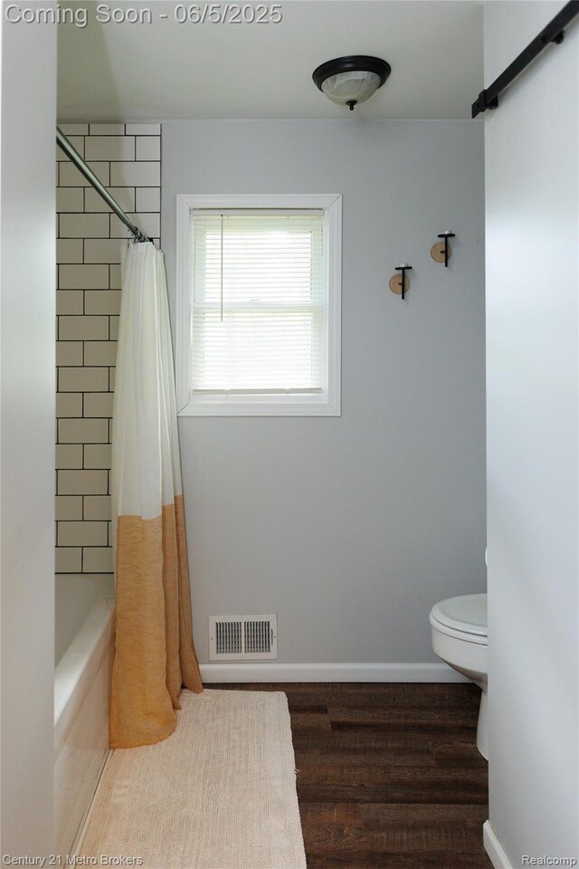 4447 Stanley Rd, Genesee, MI 48437 - full bath with toilet, wood finished floors, shower / tub combo, and baseboards