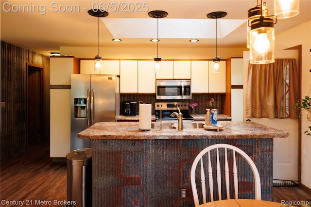 4447 Stanley Rd, Genesee, MI 48437 - kitchen with stainless steel appliances, dark wood-style floors, white cabinets, a center island with sink, and recessed lighting