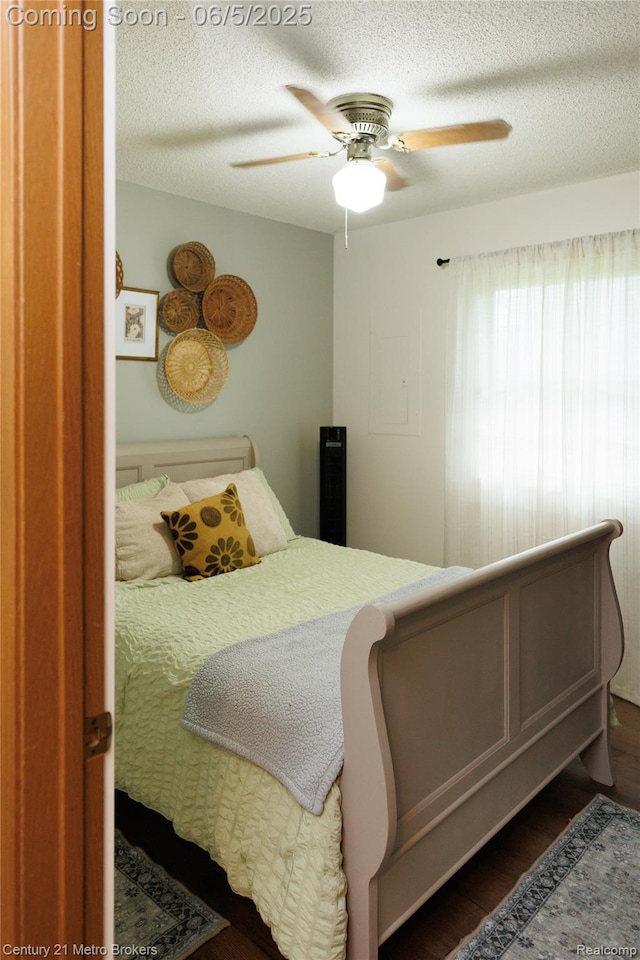 4447 Stanley Rd, Genesee, MI 48437 - bedroom with dark wood-style floors, a textured ceiling, and a ceiling fan