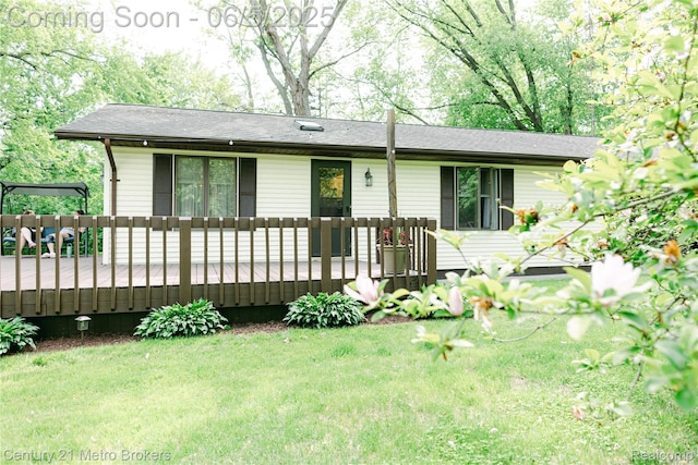 4447 Stanley Rd, Genesee, MI 48437 - ranch-style home with a wooden deck and a front lawn