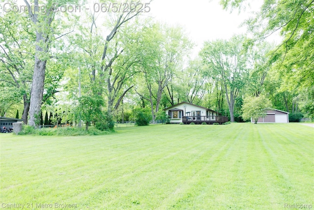 4447 Stanley Rd, Genesee, MI 48437 - view of grassy yard with an outbuilding, a deck, and a detached garage