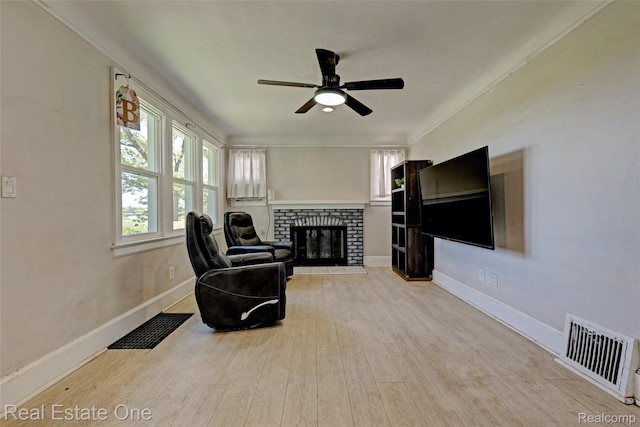 86 Marquette St, Pontiac, MI 48342 - living room featuring wood finished floors, a brick fireplace, a ceiling fan, baseboards, and ornamental molding