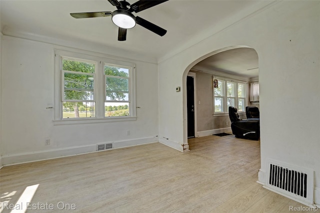 86 Marquette St, Pontiac, MI 48342 - empty room featuring arched walkways, wood finished floors, a ceiling fan, and baseboards