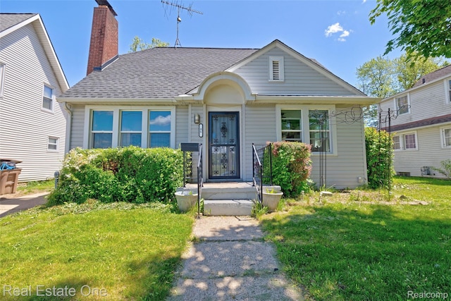 86 Marquette St, Pontiac, MI 48342 - bungalow with a front lawn, a shingled roof, and a chimney