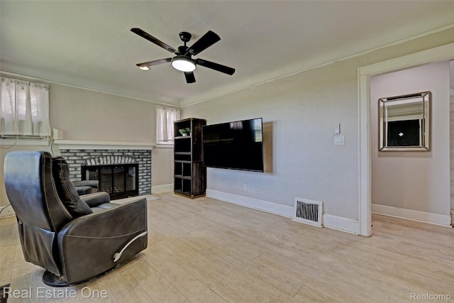 86 Marquette St, Pontiac, MI 48342 - living room featuring a ceiling fan, a fireplace, baseboards, wood finished floors, and ornamental molding