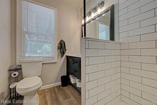86 Marquette St, Pontiac, MI 48342 - bathroom with vanity, toilet, healthy amount of natural light, and wood finished floors