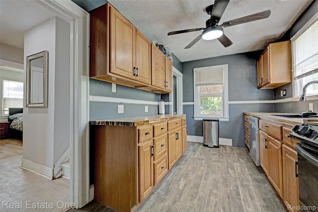 86 Marquette St, Pontiac, MI 48342 - kitchen with dishwasher, a sink, light wood-style floors, ceiling fan, and a textured ceiling