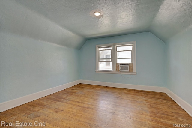 86 Marquette St, Pontiac, MI 48342 - bonus room with lofted ceiling, a textured ceiling, wood finished floors, baseboards, and cooling unit