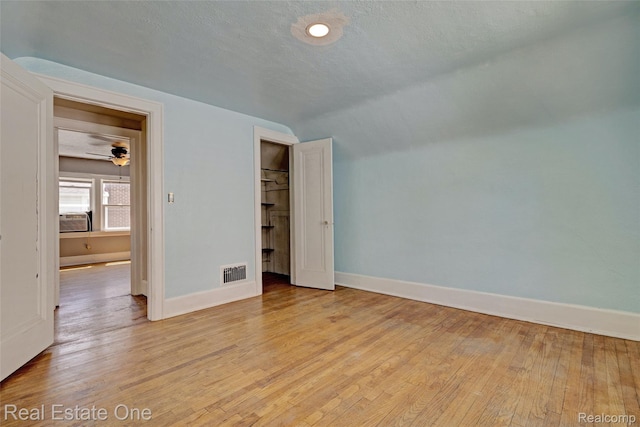 86 Marquette St, Pontiac, MI 48342 - unfurnished bedroom featuring baseboards, light wood finished floors, cooling unit, lofted ceiling, and a closet